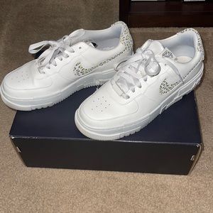 Nike Air Force ones with leopard swoosh .